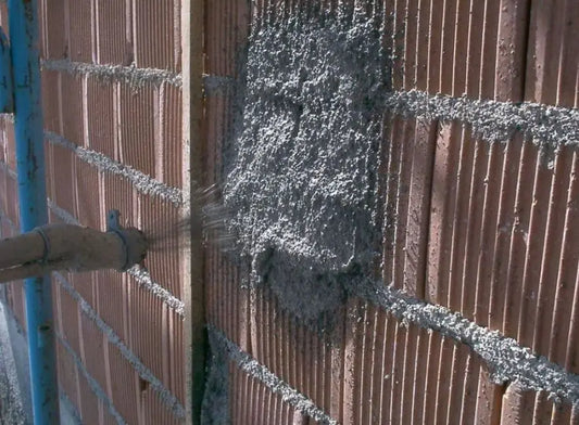 Person applying diathonite to a brick wall