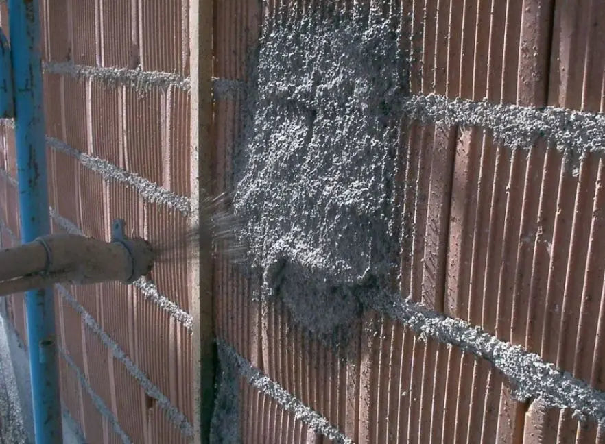 Person applying diathonite to a brick wall