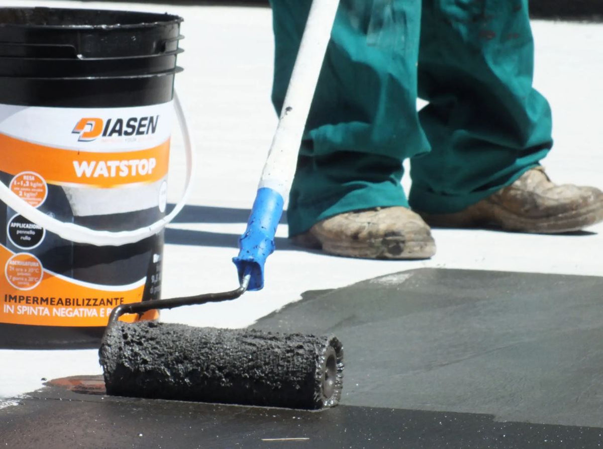 man with roller applying WATstop to outdoor surface
