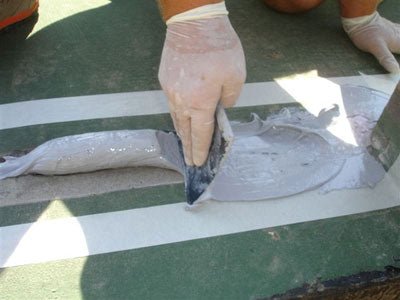 hands troweling on diaseal