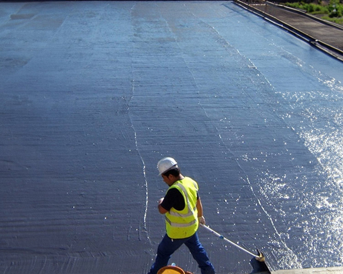 worker in safety vest applying ultragum to an exterior surface