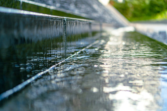 Water cascading and splashing across a surface.