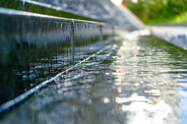 Water cascading and splashing across a surface.