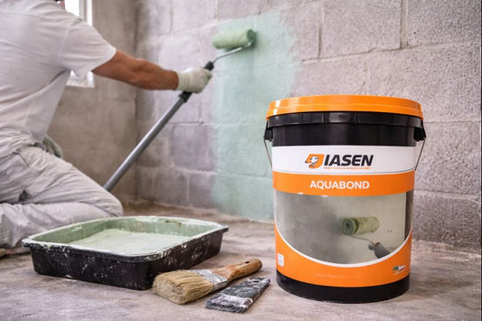 Rolling Aquabond bonding primer onto a block wall, green key coat