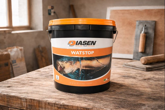 WATstop three-component waterproofing pail on a workbench mid-renovation