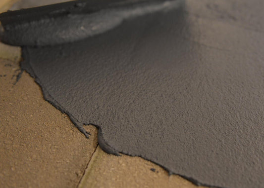 acriflex rapido being applied to brick surface with a trowel