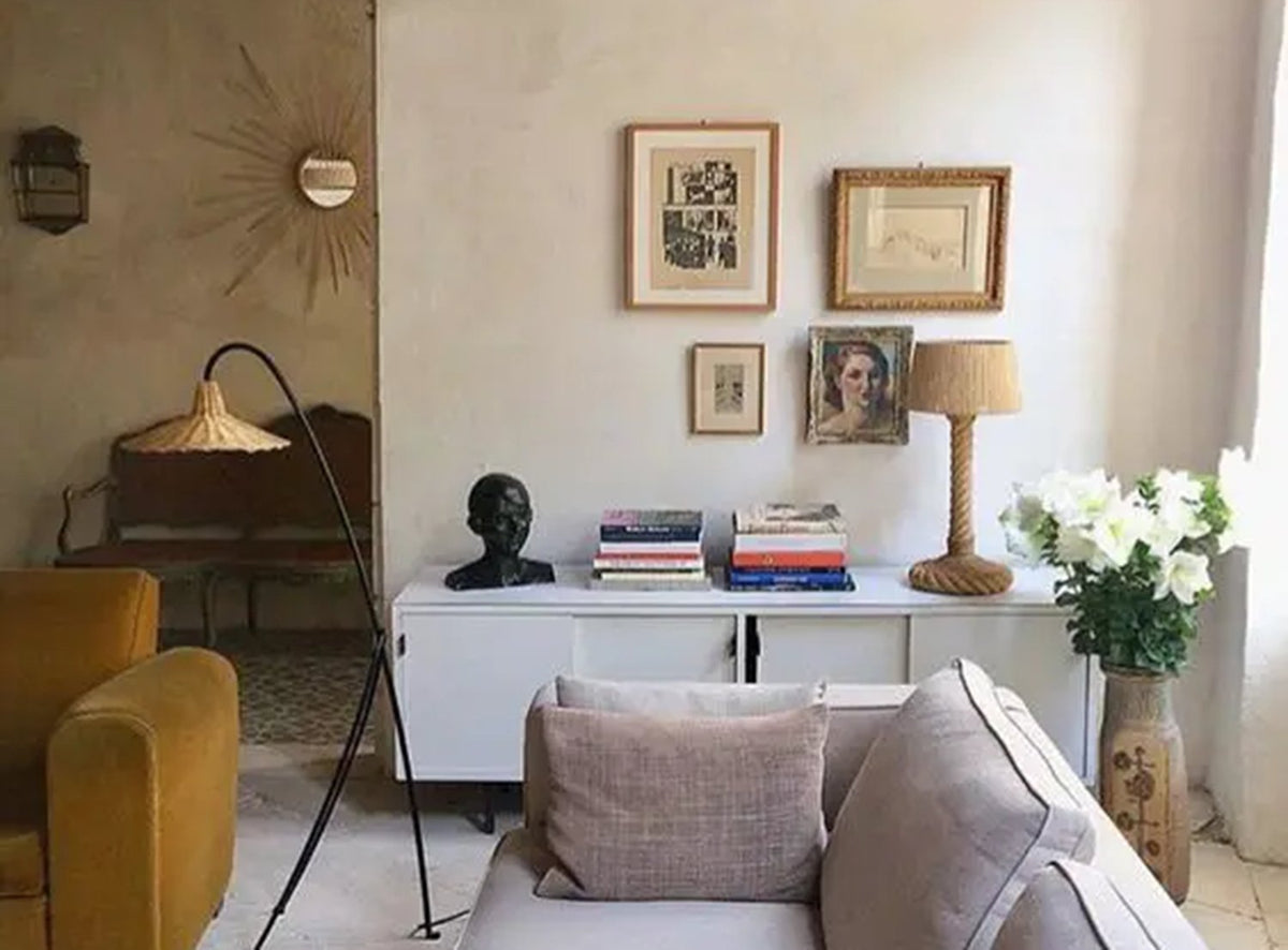 a living room with soft beige walls, neutral accents and a mustard yellow vhair